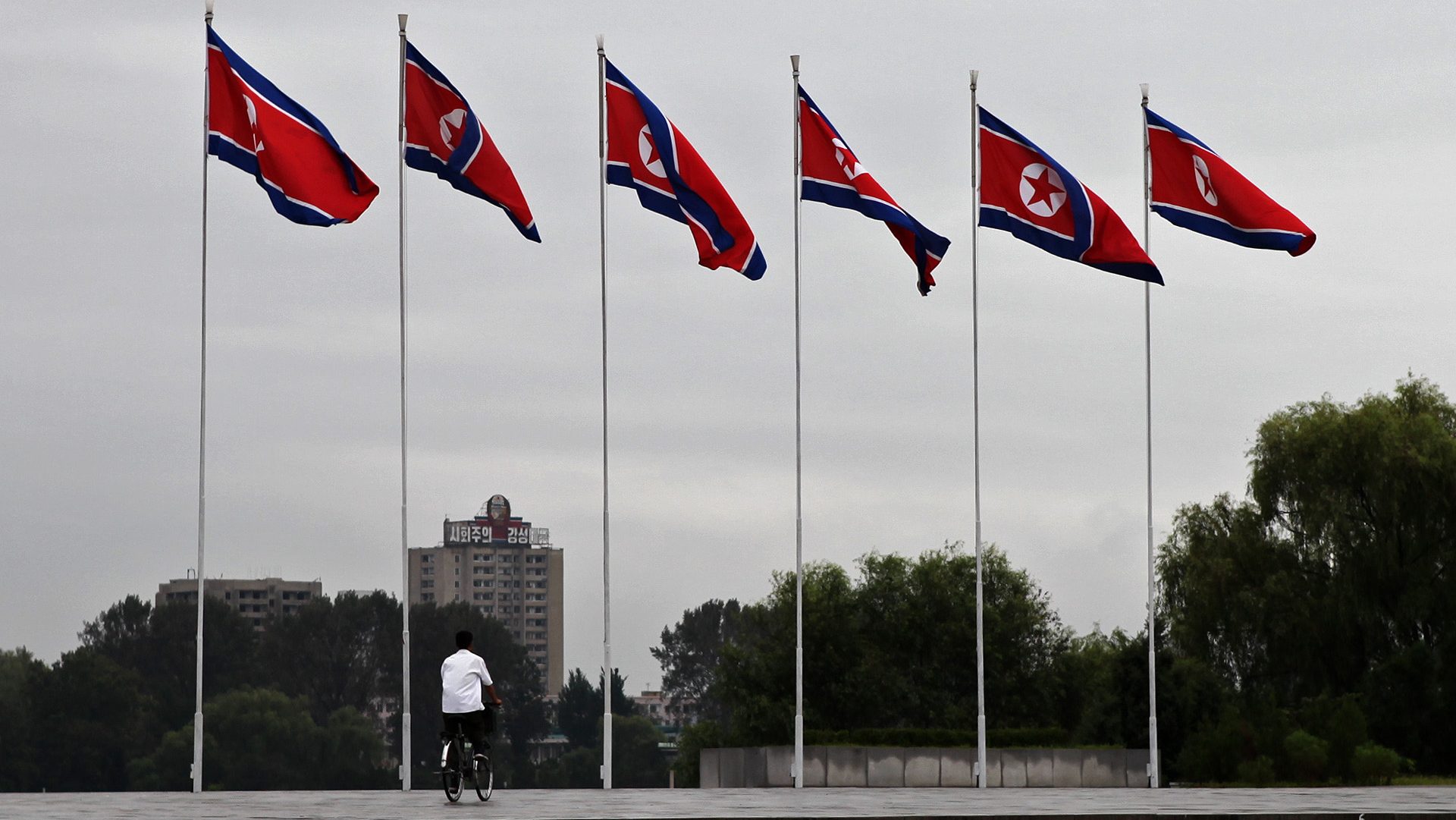 Flags of Korea flying on flag poles in Pyongyang, DPRK.