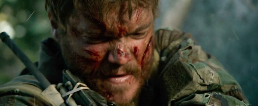 Lone Survivor 2013 Danny Dietz with blood on his face while in a firefight
