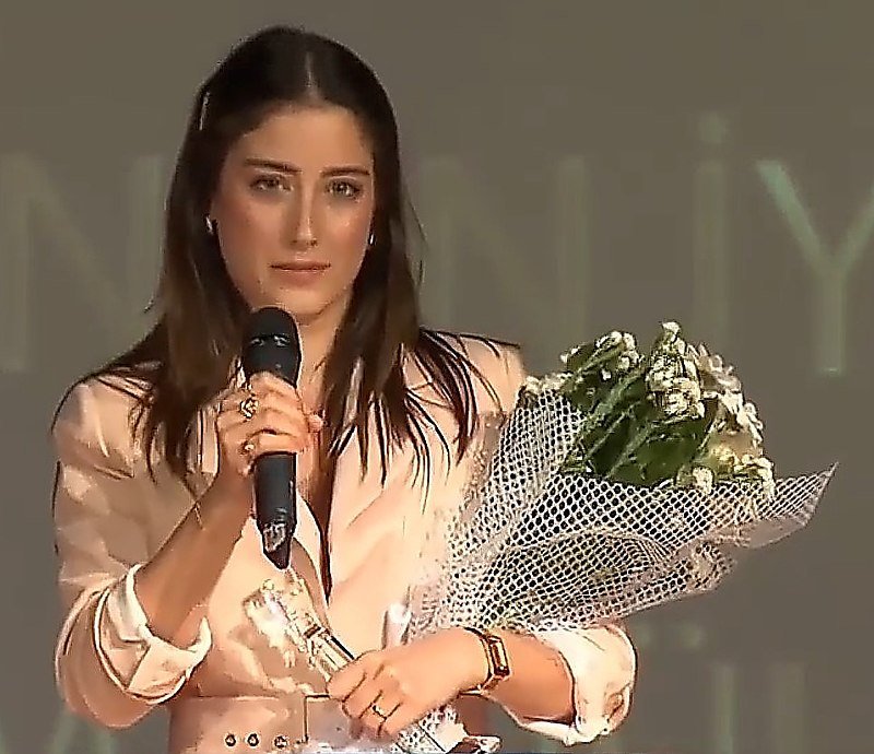 Hazal Kaya with a microphone
