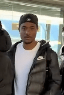 Man looking at the camera while being shouted at