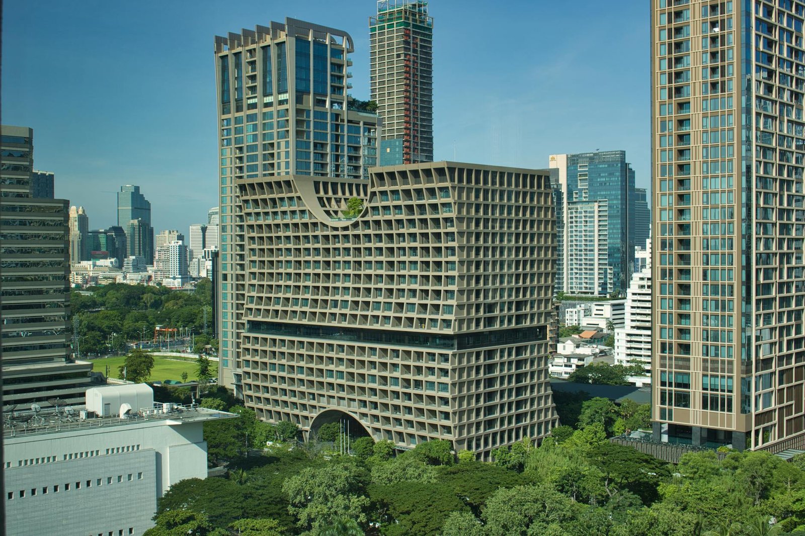 white concrete building near green trees