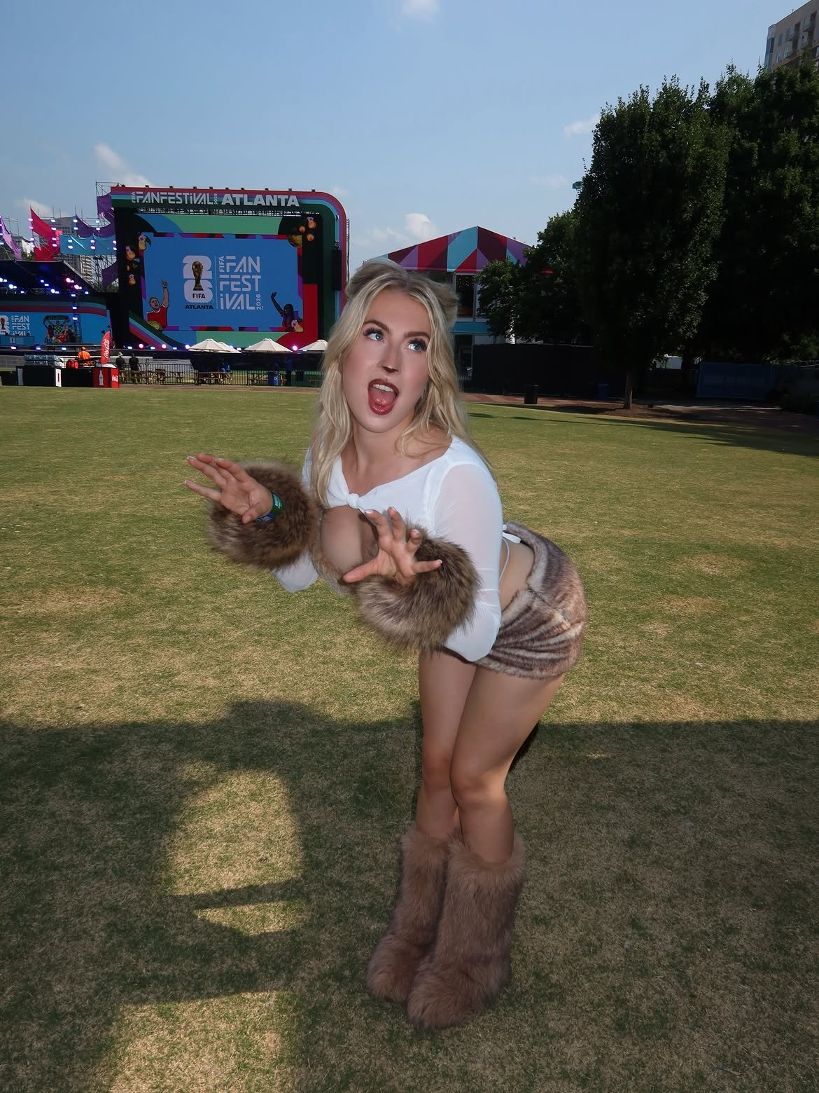 Astrid Wett leaning forward in Lioness costume with faux-fur boots at FIFA Fan Festival Atlanta