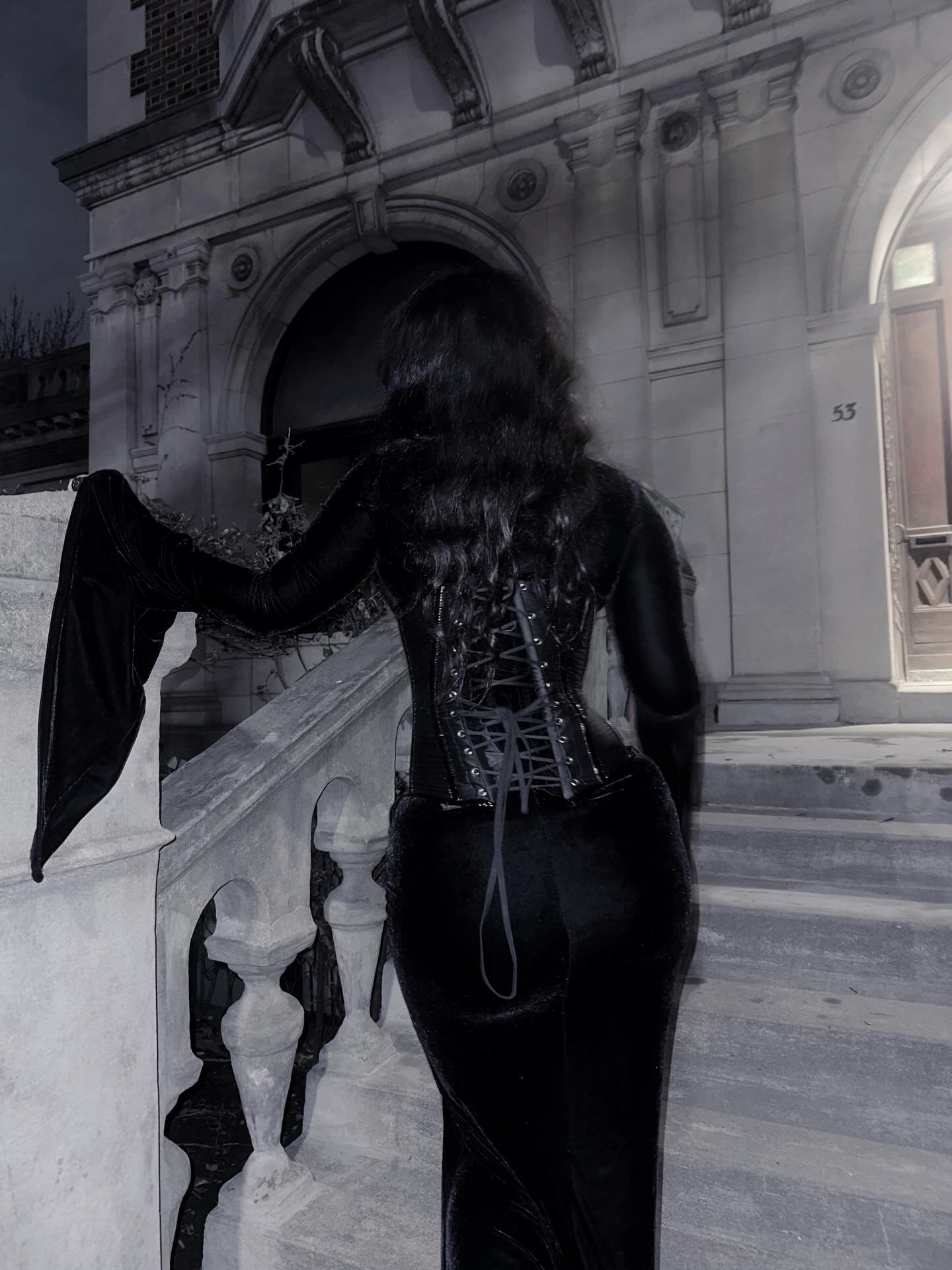 Ghoulishbats from behind showing lace-up corset back and bat wing sleeve detail at night