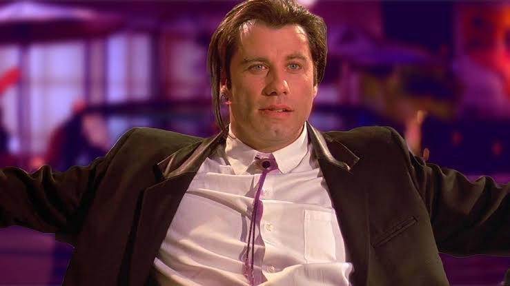 Pulp Fiction - John Travolta sitting down, looking at the camera.
